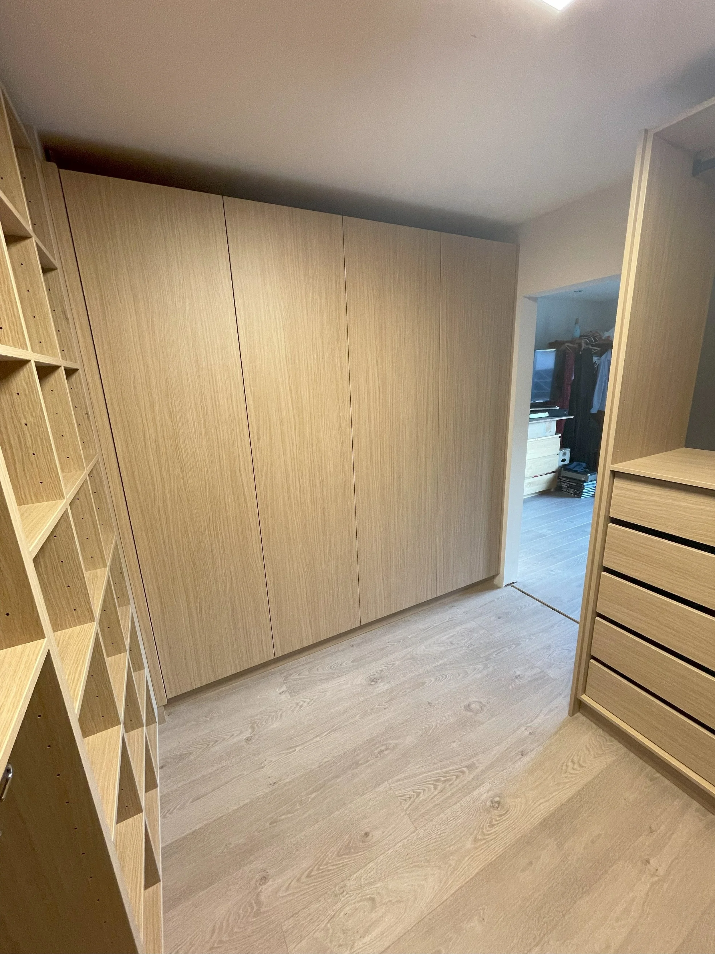 Detail van de indeling van de inloopdressing in houtdecor melamine